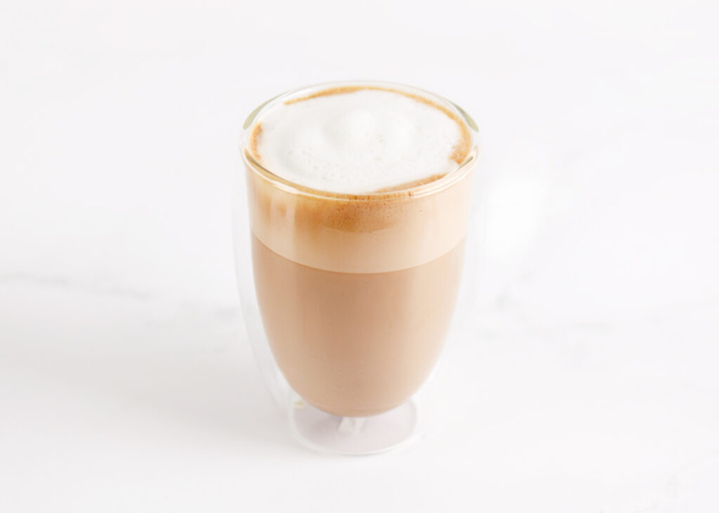 A coffee drink in a glass cup.