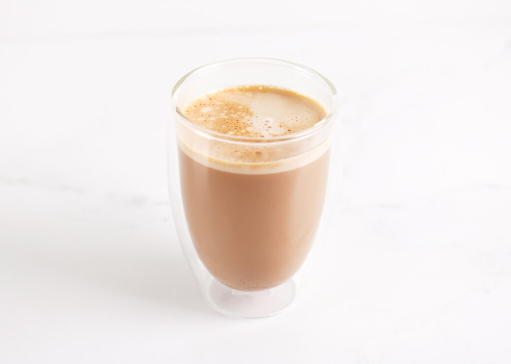 A Latte in an insulated cup.